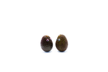 Romantic avocados couple with googly eyes as man and woman, funny food concept for creative projects