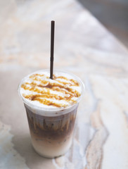 iced caramel coffee on marble white table