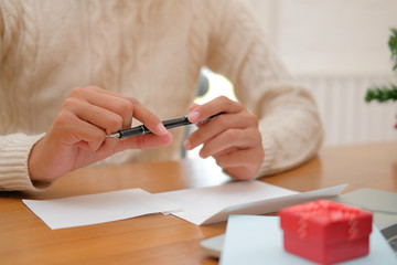 man thinking writing christmas letter greeting card holiday wishes with xmas decoration