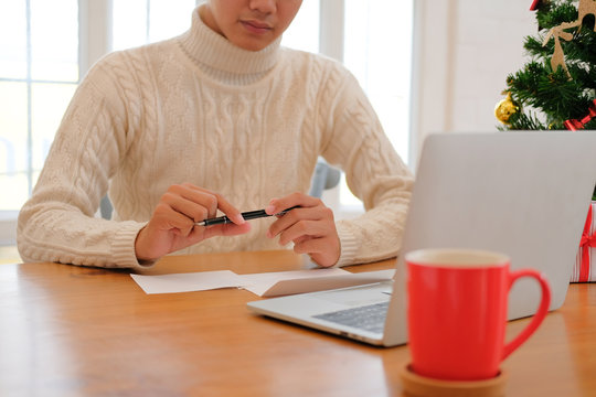 man thinking writing christmas letter greeting card holiday wishes with xmas decoration