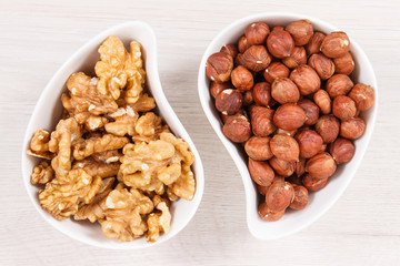 Hazelnuts and walnuts in white bowl, healthy nutrition and lifestyle concept