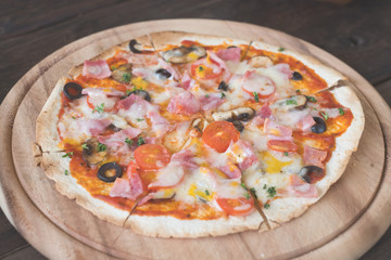 closeup pizza on wood plate