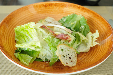 closeup cesar salad with chicken and bacon