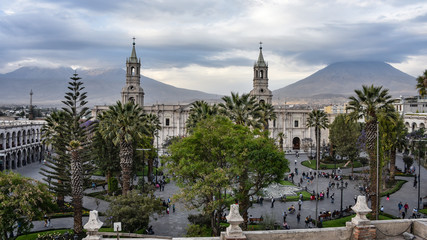 Fototapeta na wymiar Arequipa, Peru - October 7, 2018: The Plaza de Armas and Arequipa Cathedral with the backdrop of El Misti volcano