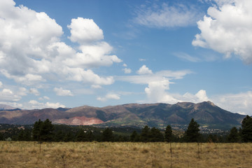 Scenic mountains, blue sky with white clouds on a summer sunny day. Scenic overlook. Colorado, USA.