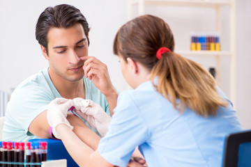 Young patient during blood test sampling procedure  