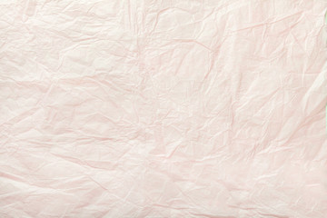 Texture of crumpled white wrapping paper, closeup. Coral old background.