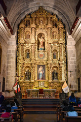 Fototapeta premium Arequipa, Peru - October 6, 2018 - Interior of Jesuit Church La compania. One of the oldest in the city noted for its ornate facade and main altar covered in gold leaf.