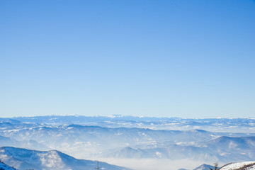 Amazing panorama from top of Kopaonik Mountain Serbia towards one of the peaks of mountains surrounding Kosovo during winter 