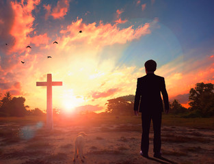 Thanksgiving concept: a businessman standing in front of the cross