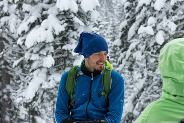 Fototapeta na wymiar portrait of male freerider in snowfall in winter forest
