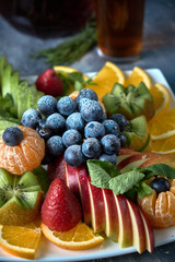 Obraz na płótnie Canvas fruit plate. Glass bank of lemonade with sliced citrus fruits on a buffet table