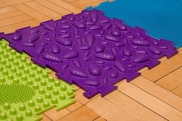 Massage pad for the feet. Purple rug with knobs