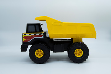 Fototapeta na wymiar Yellow toy dump truck isolated on white background