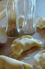 Fototapeta na wymiar Dumplings sprinkled with flour on the kitchen counter