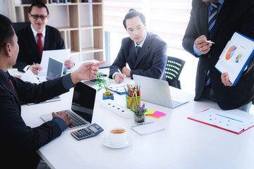 Businessman presenting show making graphs and charts during meeting at office. Teamwork successful meeting workplace strategy concept.