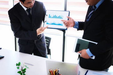 Business man and partner presentation graph chart of company's marketing share in meeting room.
