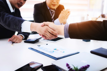 Business people shaking hands after finishing up a meeting good teamwork in office.Teamwork successful Meeting Workplace strategy Concept.