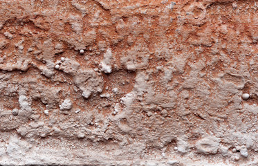 Texture of red clay wall. Red clay earth for background usage. Texture of the old tough cragged wall of red color