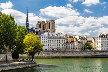 Fototapeta na wymiar The two towers of Notre Dame de Paris church in France seen from Louis Philippe bridge on the Seine on a summer day