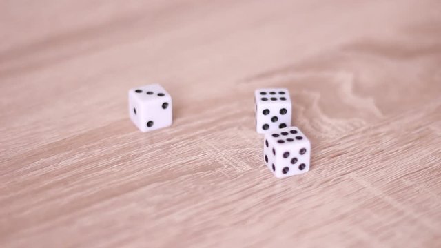 Throwing dice on table and taking it back