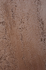 Rustic yellow uneven wall loft design. Textured background of painted stone wall. Old background of a yellow shade.