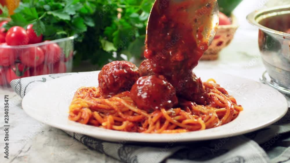 Wall mural Serving spaghetti with meatballs in tomato sauce