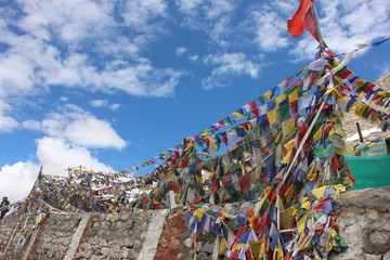 buddhist prayer flags on hilltop