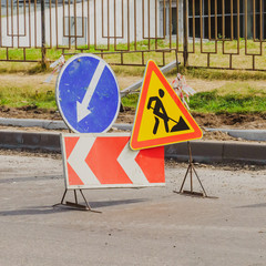 Work in progress. Roadworks, road signs. Men at work. Some signs signage for work in progress on...