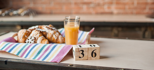Breakfast pregnant. Croissants and orange juice. Cubes with numbers 36 weeks.