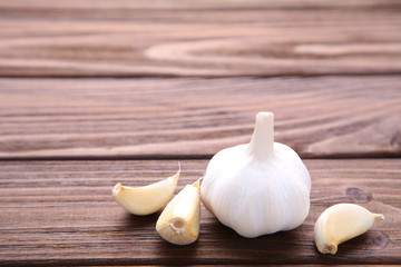 Fresh garlic on a brown wooden background