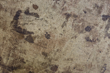 Dark brown spots on the surface of beige cardboard.