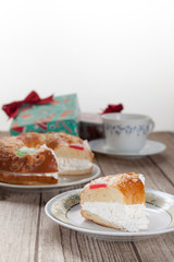 Spanish typical dessert of epiphany  cut piece on plate on white background