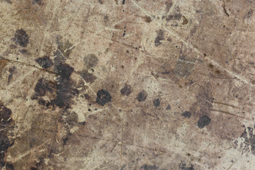 Dark brown spots on the surface of beige cardboard.