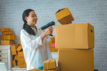 Business woman owner or freelance woman working at home with use bluetooth barcode scanner for save...