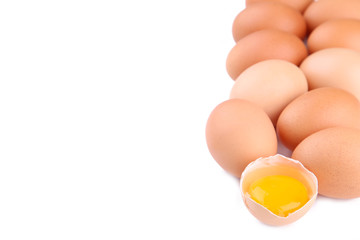 Chicken eggs and half with yolk on a white background.