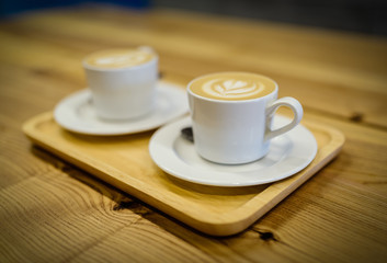 Closeup view of two cups with coffee. Shallow depth of field.