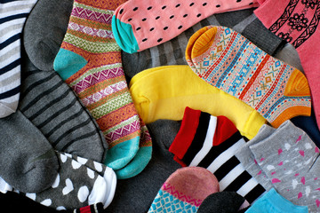 A pile of multi-colored socks. View from above. Many colorful socks form a textural background....