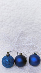 New year, christmas greeting card. Three blue christmas-tree ball on shiny snow background.