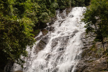 Fototapeta na wymiar Beautiful waterfall flowing through a tropical rain forest in Thailand (Ton Prai, Lam Ru, Thailand)