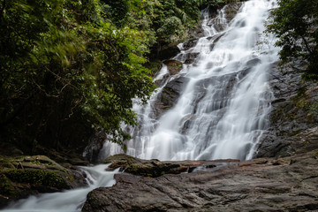 Naklejka premium Beautiful waterfall flowing through a tropical rain forest in Thailand (Ton Prai, Lam Ru, Thailand)