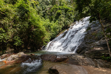 Beautiful waterfall flowing through a tropical rain forest in Thailand (Ton Prai, Lam Ru, Thailand)