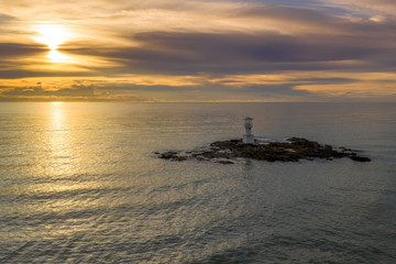 Aerial drone view of a lighthouse at sunset over a tropical ocean (Khao Lak, Thailand)