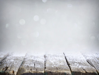 Abstract christmas silver background with empty wooden table and snow 