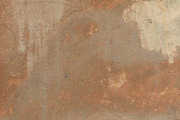 Old plaster walls with remnants of brown paint. Grunge texture.