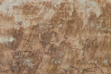 Old plaster walls with remnants of brown paint. Grunge texture.