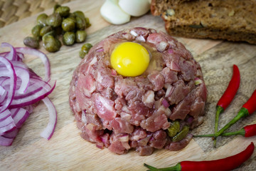tasty Steak tartare, raw beef - classic steak tartare on wood board