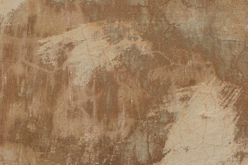 Old plaster walls with remnants of brown paint. Grunge texture.
