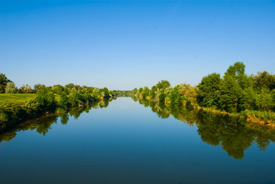 quiet irregation channel leaving far under a blue sky