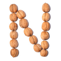 Letter N made with nuts to form a letter of the alphabet. Fruit letters on a white background.